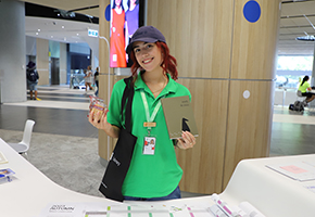 Student Guide holding notebook, cookies and tote.